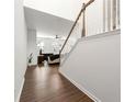 Inviting entryway featuring hardwood floors, staircase with white railings, and view to a cozy living room at 3848 Hester St, Duluth, GA 30097