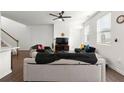 Bright living room features white walls, ceiling fan, lots of natural light, and comfortable couches at 3848 Hester St, Duluth, GA 30097