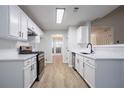 Bright kitchen featuring white cabinets, stainless steel appliances, and updated countertops at 2545 Davenport Park Dr, Duluth, GA 30096