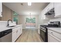 Well-lit kitchen with white cabinets, quartz counters and stainless steel oven/range at 2545 Davenport Park Dr, Duluth, GA 30096