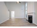 Open living room featuring high ceilings, fireplace, and large windows for natural light at 2545 Davenport Park Dr, Duluth, GA 30096
