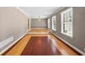 Spacious living area with abundant natural light, unique flooring, and elegant chandelier at 3188 Sunnyford Ln, Lithonia, GA 30038