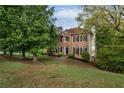 Traditional brick home with a well-maintained lawn and mature trees, offering curb appeal at 507 Matthew Dr, Canton, GA 30115