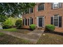 Close-up of a classic brick home with a welcoming front entrance and manicured landscaping at 507 Matthew Dr, Canton, GA 30115