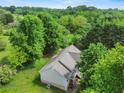 Aerial view of the home highlighting its peaceful, wooded setting at 5711 Parks Rd, Cumming, GA 30041