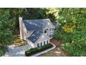 Aerial view of the home with mature trees, an attached garage, and backyard at 6815 Fairgreen Dr, Suwanee, GA 30024