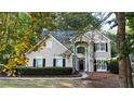 View of front exterior with a manicured lawn, a bench, and a landscaped yard at 6815 Fairgreen Dr, Suwanee, GA 30024