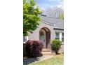 Close up of the arched front door entrance with a wreath and surrounding greenery at 812 E Ponce De Leon Ave, Decatur, GA 30030