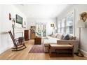Cozy living room features a fireplace, hardwood floors, a comfortable sectional, and natural light at 812 E Ponce De Leon Ave, Decatur, GA 30030