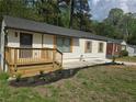 One-story home with a modern front door, a deck, and tidy landscaping at 2065 Verbena St, Atlanta, GA 30314