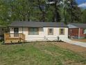 Inviting one-story home with a small porch, new landscaping, and a well-manicured lawn at 2065 Verbena St, Atlanta, GA 30314