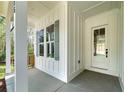 Inviting covered front porch with stylish accents showcasing the home's architectural details and providing a welcoming entrance at 4725 Young Deer Dr, Cumming, GA 30041