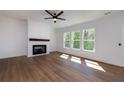 Bright living room with a cozy fireplace, complemented by large windows that fill the space with natural light and warmth at 4725 Young Deer Dr, Cumming, GA 30041