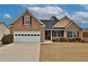 Charming single-story brick home with an attached two car garage and manicured front lawn at 1104 Aqua Shore Dr, Mcdonough, GA 30252
