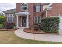 Inviting entrance with a manicured lawn, walkway and covered front door at 115 Westbury Ln, Johns Creek, GA 30005