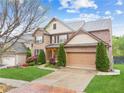 Charming two-story brick home with lush landscaping, a two-car garage, and inviting curb appeal at 2539 Larson Creek Cove, Duluth, GA 30097