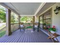 Relaxing covered front porch with rocking chairs, wood floors, wood railing, and shade to enjoy outdoor living at 3046 Valley Cir, Decatur, GA 30033