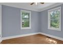 Bright bedroom with hardwood floors, trim, and two sunny windows with views at 5942 Morgan Rd, Atlanta, GA 30340