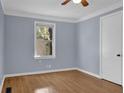 Inviting bedroom with hardwood floors, modern ceiling fan, and a bright window at 5942 Morgan Rd, Atlanta, GA 30340