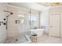 Beautiful bathroom featuring a free-standing tub, glass enclosed shower, and a decorative leaded glass window at 5945 Boulder Bluff Dr, Cumming, GA 30040