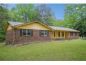 Attractive single-story home with a brick facade, complemented by a well-manicured lawn and simple landscaping at 8540 Ridge Rd, Fairburn, GA 30213