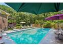 Lush backyard pool with seating areas and mature landscaping at 8540 Ridge Rd, Fairburn, GA 30213