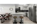 Well-lit open concept kitchen features stainless steel appliances and island seating with room for dining at 2965 Pharr Court South Nw # 304, Atlanta, GA 30305