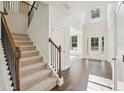 Grand foyer with hardwood floors, staircase with iron railings, and a view to the living spaces at 5816 Creek Indian Dr, Sugar Hill, GA 30518