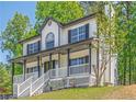 Beautiful two-story home showcasing a lovely front porch and lush green surroundings at 1331 Windage Sw Ct, Marietta, GA 30008