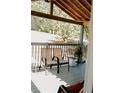 View of the covered porch, furnished with chairs for relaxing outdoors at 153 Helen Rd, Covington, GA 30016