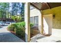 Condo entryway featuring a covered entrance with manicured greenery and outdoor light fixture at 407 Coleraine Se, Smyrna, GA 30080