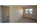 Cozy bedroom featuring neutral carpet, bright natural light from a window, and doorway to another room at 475 Mount Vernon Ne Hwy # C-220, Sandy Springs, GA 30328