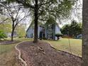 Lovely home with landscaped yard and mature trees create a serene setting at 3147 Pine Needle Sw Ct, Lilburn, GA 30047