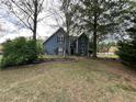 Charming blue two-story home featuring a lush landscaped yard at 3147 Pine Needle Sw Ct, Lilburn, GA 30047