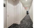 Well-lit hallway with carpet flooring, white walls, unit number, and clean design at 1065 Peachtree Ne St # 2803, Atlanta, GA 30309