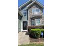 The house features a charming front entrance with stone accents and manicured landscaping at 1015 Pebble Creek Trl, Suwanee, GA 30024