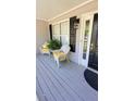 Inviting front porch with seating, decorative plants, and a view of the entryway at 1084 Whistle Dr, Austell, GA 30106