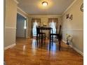 Cozy dining area featuring gleaming hardwood floors and natural light at 128 Brookhaven Ln, Mcdonough, GA 30253