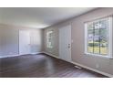 Bright living room featuring fresh paint, laminate flooring, and natural light from large windows at 4684 City View Dr, Forest Park, GA 30297