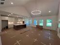 Spacious living room and kitchen combo featuring modern lighting, island, and lots of natural light at 500 Level Creek Rd, Sugar Hill, GA 30518