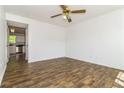 Bright living room with wood flooring, ceiling fan, and adjacent kitchen at 5880 Trent Walk Dr, Lithonia, GA 30038