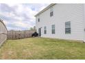 Large, grassy backyard with a tall wooden fence, perfect for outdoor activities at 88 Oxford Ln, Kingston, GA 30145
