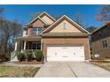 Beautiful home showcasing a well-maintained lawn and attached two-car garage at 3482 Willow Meadow Ln, Douglasville, GA 30135