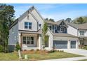 Beautiful two-story home with a well-manicured lawn and a two-car garage at 461 Maypop Ln, Woodstock, GA 30188