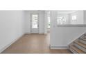 Bright living room with hardwood floors and a view of the front yard at 461 Maypop Ln, Woodstock, GA 30188