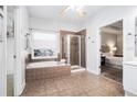 Elegant bathroom with a soaking tub, glass-enclosed shower, and tile flooring at 2069 Willow Chase Ct, Tucker, GA 30084
