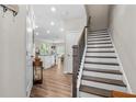 Welcoming entryway features wood-look floors, staircase, and a glimpse into the bright, open kitchen at 3377 Park Pointe Cir, Scottdale, GA 30079