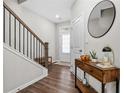 Inviting entryway with wood floors, modern staircase, console table, and contemporary mirror at 3377 Park Pointe Cir, Scottdale, GA 30079
