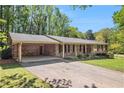 Charming brick home featuring a covered carport and well-maintained landscaping, enhancing its curb appeal at 504 Baltimore Sw Ave, Lilburn, GA 30047