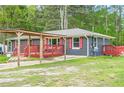 View of a one-story home with a carport, brick exterior, and red shutters at 846 Orris Ln, Mableton, GA 30126